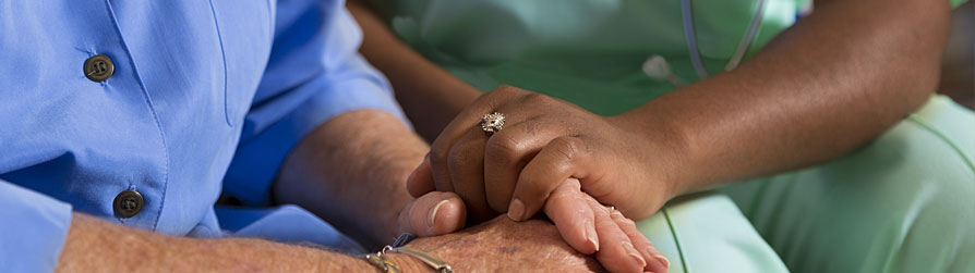 Medical provider holding hand of patient