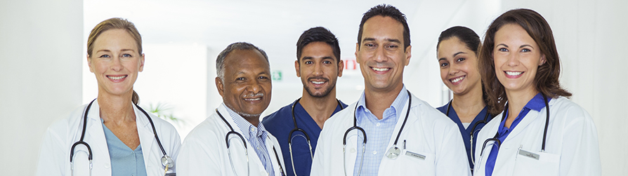 Six medical providers smiling and looking into camera