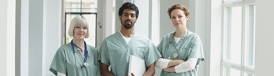 Three medical providers looking at camera